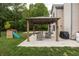 Serene backyard with a covered patio, comfortable seating, and a fun playground, perfect for outdoor living at 1680 Arbor Springs Dr, Brownsburg, IN 46112
