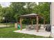 Spacious backyard featuring a covered patio, playground, and basketball court, perfect for outdoor activities and relaxation at 1680 Arbor Springs Dr, Brownsburg, IN 46112