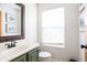 Bathroom featuring a sink with dark wood framed mirror and natural light at 1680 Arbor Springs Dr, Brownsburg, IN 46112
