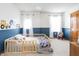 Cozy bedroom with a toddler bed, blue accent wall, and playful decor creating a fun and inviting space at 1680 Arbor Springs Dr, Brownsburg, IN 46112