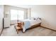 Simple bedroom with large window, carpeted floor, and a bedside table providing a comfortable and minimalist space at 1680 Arbor Springs Dr, Brownsburg, IN 46112