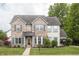 Charming two-story home with a brick facade, manicured lawn, and beautiful landscaping at 1680 Arbor Springs Dr, Brownsburg, IN 46112