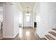 Bright foyer featuring dark wood floors and staircase at 1680 Arbor Springs Dr, Brownsburg, IN 46112