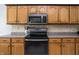 Close up of the kitchen featuring a range and wood cabinets at 1680 Arbor Springs Dr, Brownsburg, IN 46112