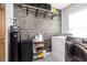 Well-organized laundry room featuring stylish wood paneling, modern appliances, and ample storage at 1680 Arbor Springs Dr, Brownsburg, IN 46112