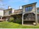 Backyard of the home showcasing a screened-in porch and a wooden deck, perfect for outdoor enjoyment at 1726 Creekside W Ln, Carmel, IN 46032