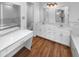 Bright bathroom featuring dual sinks, white cabinets, modern lighting, and a vanity area at 1726 Creekside W Ln, Carmel, IN 46032