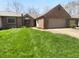 Charming brick home featuring an attached two-car garage and well-maintained front lawn at 1726 Creekside W Ln, Carmel, IN 46032