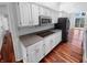 Well-lit kitchen with stainless steel microwave and cooktop, with hardwood floors at 1726 Creekside W Ln, Carmel, IN 46032