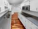 Modern kitchen with stainless steel sink, cooktop, and white cabinetry at 1726 Creekside W Ln, Carmel, IN 46032