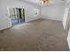 Spacious living room with sliding door to screened porch and plush carpeting at 1726 Creekside W Ln, Carmel, IN 46032
