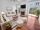 Bright living room features hardwood floors, a fireplace, and access to an outdoor deck at 1726 Creekside W Ln, Carmel, IN 46032