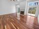 Spacious living room features hardwood floors, a fireplace, and access to an outdoor deck at 1726 Creekside W Ln, Carmel, IN 46032