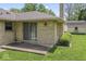 Brick home features a small concrete back patio and a sliding glass door at 1817 Edgewood Dr, Anderson, IN 46011
