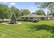 Spacious backyard with mature trees and landscaping surrounding this well-maintained home at 1817 Edgewood Dr, Anderson, IN 46011