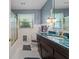This bathroom includes a stylish vanity with a unique countertop and ample lighting at 1817 Edgewood Dr, Anderson, IN 46011
