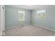 Neutral carpet and updated windows are showcased in this well-lit bedroom at 1817 Edgewood Dr, Anderson, IN 46011