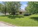 Well-maintained home features mature trees, a lush lawn, and desirable neighborhood at 1817 Edgewood Dr, Anderson, IN 46011