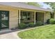 Inviting covered front porch features updated brickwork, trim, and manicured landscaping at 1817 Edgewood Dr, Anderson, IN 46011