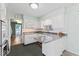 Open kitchen featuring white cabinets, granite countertops, and modern appliances at 1817 Edgewood Dr, Anderson, IN 46011