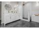 Bright bathroom with double sink vanity, modern fixtures, and marble-tiled shower at 1825 E Maryland St, Indianapolis, IN 46201