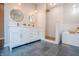 Bright bathroom featuring double vanity, vessel sinks, sleek fixtures, a walk-in shower, and a soaking tub at 1825 E Maryland St, Indianapolis, IN 46201