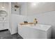 Modern bathroom with a freestanding tub, marble surround, and gold accents at 1825 E Maryland St, Indianapolis, IN 46201