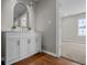 Bathroom vanity with potted plants and a sleek mirror, with an open door to a bedroom in the background at 1825 E Maryland St, Indianapolis, IN 46201