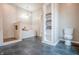 Bright bathroom showcases a walk-in shower, soaking tub, built-in shelving, and toilet at 1825 E Maryland St, Indianapolis, IN 46201