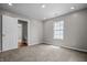 Clean bedroom with neutral carpet and one window, adjacent to a partial bathroom; perfect for restful privacy at 1825 E Maryland St, Indianapolis, IN 46201