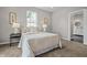 Cozy bedroom featuring neutral tones, bedside tables with lamps, and an ensuite bathroom at 1825 E Maryland St, Indianapolis, IN 46201