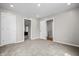 Spacious bedroom featuring neutral carpeting, recessed lighting, and multiple doors for easy access to other areas of the home at 1825 E Maryland St, Indianapolis, IN 46201