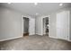 Spacious bedroom featuring neutral carpeting, recessed lighting, and multiple doors for easy access to other areas of the home at 1825 E Maryland St, Indianapolis, IN 46201