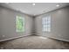 Bright bedroom featuring neutral colored walls, carpeting, and two windows with natural light at 1825 E Maryland St, Indianapolis, IN 46201