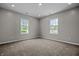 Bright, airy bedroom with neutral carpet and two windows offering natural light; perfect for rest and relaxation at 1825 E Maryland St, Indianapolis, IN 46201
