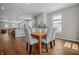 Open-concept dining area with a wooden table and gray chairs adjacent to a modern kitchen, perfect for entertaining at 1825 E Maryland St, Indianapolis, IN 46201