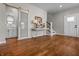 Entryway featuring hardwood floors, sliding barn door, and staircase at 1825 E Maryland St, Indianapolis, IN 46201