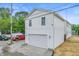 A three story white house with a two car garage and multiple windows with natural light at 1825 E Maryland St, Indianapolis, IN 46201