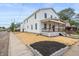 Two-story home boasting a covered porch, fresh landscaping, and a well-maintained exterior at 1825 E Maryland St, Indianapolis, IN 46201