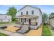 Inviting two-story home with a covered porch, stylish railings, and fresh landscaping at 1825 E Maryland St, Indianapolis, IN 46201