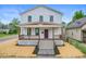 Charming two-story home with a welcoming front porch and freshly landscaped yard at 1825 E Maryland St, Indianapolis, IN 46201