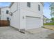 Exterior view of a detached garage showing siding, lighting, and gravel driveway at 1825 E Maryland St, Indianapolis, IN 46201