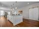 Large kitchen island with white cabinets and hardwood floors at 1825 E Maryland St, Indianapolis, IN 46201