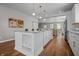 Modern kitchen featuring a central island with marble countertop and pendant lighting, seamlessly connected to an open-concept living area at 1825 E Maryland St, Indianapolis, IN 46201