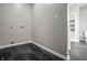 Laundry area with tile flooring, neutral walls, and built-in shelving in the next room at 1825 E Maryland St, Indianapolis, IN 46201