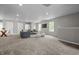 Large living space features recessed lighting, neutral walls, carpet, and multiple seating areas at 1825 E Maryland St, Indianapolis, IN 46201