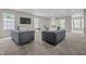 Inviting living room with two gray sofas, neutral carpet, and bright windows for a relaxing atmosphere at 1825 E Maryland St, Indianapolis, IN 46201