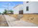 A bright white home with a manicured side yard and rock landscaping along the sidewalk at 1825 E Maryland St, Indianapolis, IN 46201