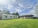 Expansive backyard view with a well-maintained lawn and a combination of storage and residential buildings at 1927 E 125 S, Franklin, IN 46131