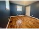 Bedroom featuring light-blue walls, white trim, and new hardwood floors and bi-fold door closet at 1927 E 125 S, Franklin, IN 46131